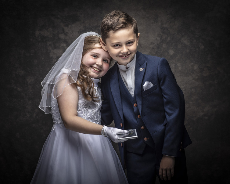 Twins having fun at their First Holy Communion portrait session at Cormac Byrne Photography, Limerick, Ireland.  